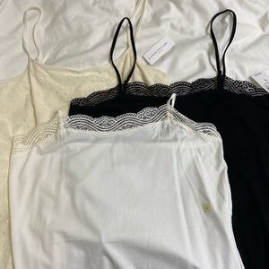Set of three Ann Taylor Camisoles. White, Black, Cream. Size Large.